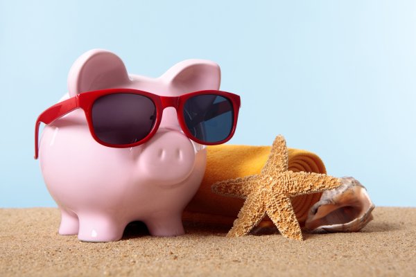 piggy bank with sunglasses on a beach credit monitoring